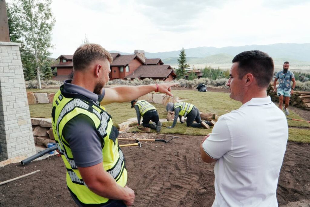Skyler Henson of Prime Landscaping directing a crew installing sod at a Park City home